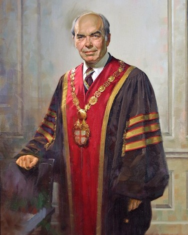 full standing portrait of a man in doctoral robes