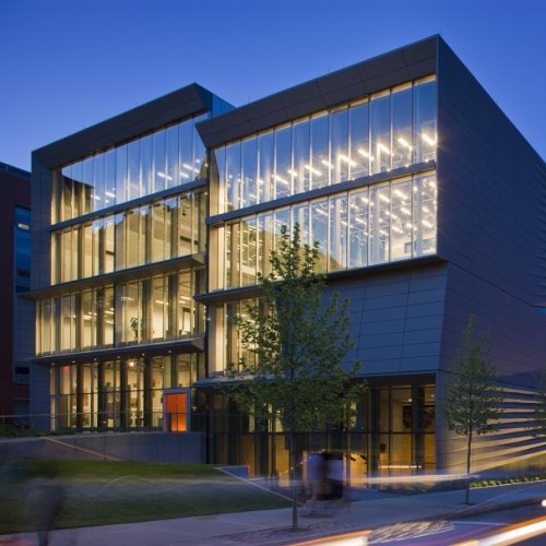 A view of the Granoff Center at night, with its lights on across all floors.