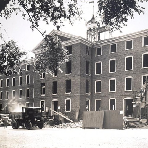 University Hall under construction, with window panes removed and scaffolding built around it